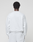 A person is seen from behind wearing the LIVE FAST DIE YOUNG Basic +49 Chest Sweater in an oversize fit, light gray shade, paired with matching shorts, standing against a plain light background.