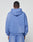 A person wearing a loose-fitting, light blue LIVE FAST DIE YOUNG Basic Hooded Zip sweatshirt and matching sweatpants stands facing away, highlighting the handcrafted fade effect against a plain light background.