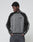 A person wears a gray and black Boxy Knit Zip Jacket by LIVE FAST DIE YOUNG, featuring Raglan sleeves and an oversize fit, with hands in pockets against a light gray background. "Diesel" is embroidered on the chest.