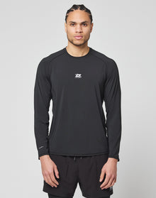 A man with braided hair wears the LIVE FAST DIE YOUNG Live Fast Performance Longsleeve in black and matching black shorts, standing facing forward against a plain light gray background.