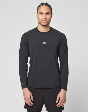 A man with braided hair wears the LIVE FAST DIE YOUNG Live Fast Performance Longsleeve in black and matching black shorts, standing facing forward against a plain light gray background.