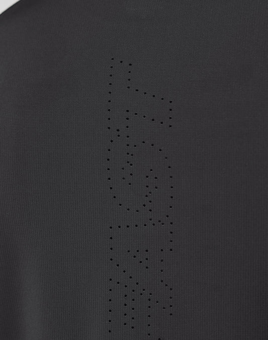 Close-up of the Live Fast Performance Longsleeve by LIVE FAST DIE YOUNG, showing black fabric with a mesh insert and perforated holes forming FAST vertically, highlighting the garment’s texture and fine details.
