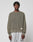 A man with short twists wears the LIVE FAST DIE YOUNG LFDY Knit Sweater, an oversized ribbed olive-green piece in 100% cotton, paired with light gray sweatpants. He stands facing forward against a plain light gray background.
