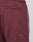 Close-up of the back of the Live Fast Trackjogger by LIVE FAST DIE YOUNG in maroon, featuring a Regular Fit, elastic waistband, back welt pocket, and white side stripe.
