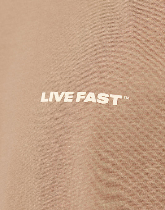 Close-up of the Live Fast Plain Tee by LIVE FAST DIE YOUNG, made from 100% brown cotton, featuring the text LIVE FAST™ as a bold white front print in capital letters.