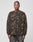 A person with a neutral expression wears the LFDY Fleece Longsleeve by LIVE FAST DIE YOUNG, featuring a green and brown camouflage-style abstract pattern, paired with faded gray jeans against a plain light background.