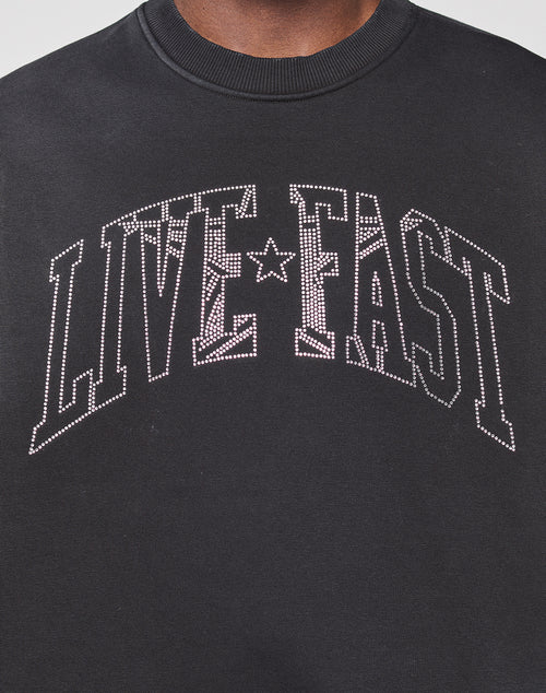 The Live Fast Rhinestone Sweater by LIVE FAST DIE YOUNG features bold, white, studded "LIVE FAST" lettering and a sparkling rhinestone logo for standout style.