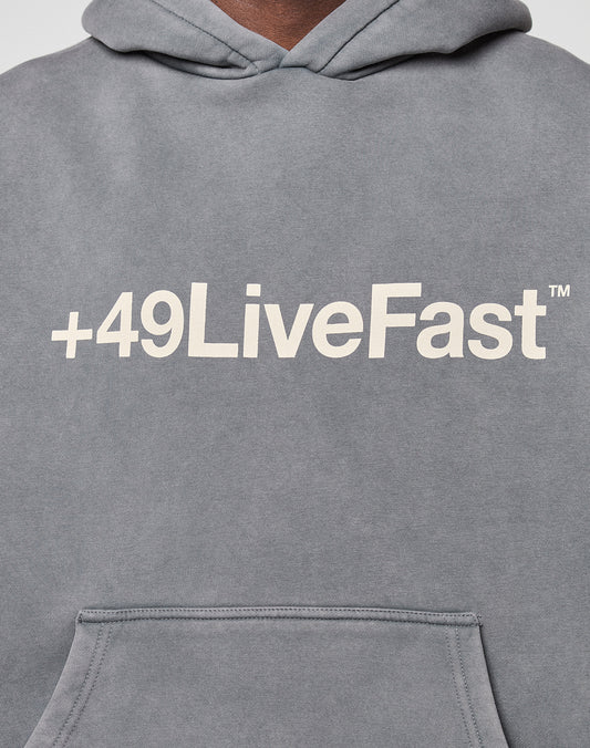 The Basic +49 Hooded by LIVE FAST DIE YOUNG is a gray oversize-fit hoodie featuring a bold white +49LiveFast™ front print. Made from soft Baumwolle, it’s shown with the upper torso and pocket for ultimate comfort.