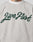 A person wears the LFDY Script Sweater by LIVE FAST DIE YOUNG, an oversize fit light gray sweatshirt with raglan sleeves and Live Fast in large green cursive on the front. A neck tattoo is visible above the collar.