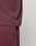 Close-up of a person in an oversize LIVE FAST DIE YOUNG Basic +49 Tee and matching sweatpants. The image highlights the soft fabric, focusing on the tee's side hem and the pants' waistband.