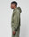 A man stands in profile against a light gray background, wearing the LIVE FAST DIE YOUNG Basic Hooded Zip and matching sweatpants in olive green with a subtle faded look.