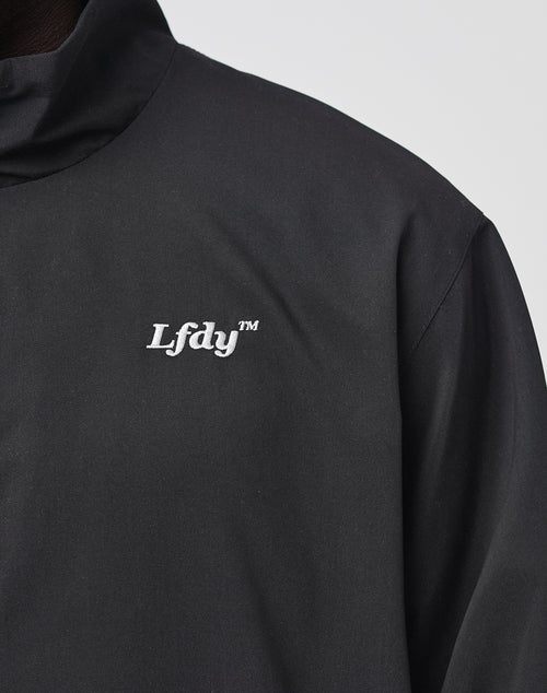 Close-up of the LFDY Trackjacket by LIVE FAST DIE YOUNG in Oversize Fit, showcasing white embroidered Lfdv™ logo on the chest, elastische Bündchen, and detailed view of the upper jacket section.