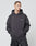 A man in an Oversize Fit LFDY Cinema Hooded by LIVE FAST DIE YOUNG, dark gray with LIVE FAST on the left chest, stands hands in pocket looking left against a light background. Cotton-poly blend ensures comfort and style.