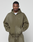 A man stands with his hands in his pockets, wearing the LIVE FAST DIE YOUNG Basic Hooded Zip and matching olive green sweatpants with an oversize fit, looking directly at the camera against a plain light background.