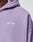 Close-up of a person wearing the LIVE FAST DIE YOUNG Basic Script Hooded Zip in light purple Vintage-Waschung, featuring Live Fast embroidered in white script on the chest; image shows neck, shoulder, and upper torso.
