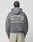 A person wearing the gray LFDY Protection Hooded Zip by LIVE FAST DIE YOUNG with front and back prints—LIVEFAST PROTECTION, Home Security UK-GER-NL, 1-800-CCTV, CCTV camera graphics. The cropped oversized fit has a hood with embroidered eyelets. Person faces away.