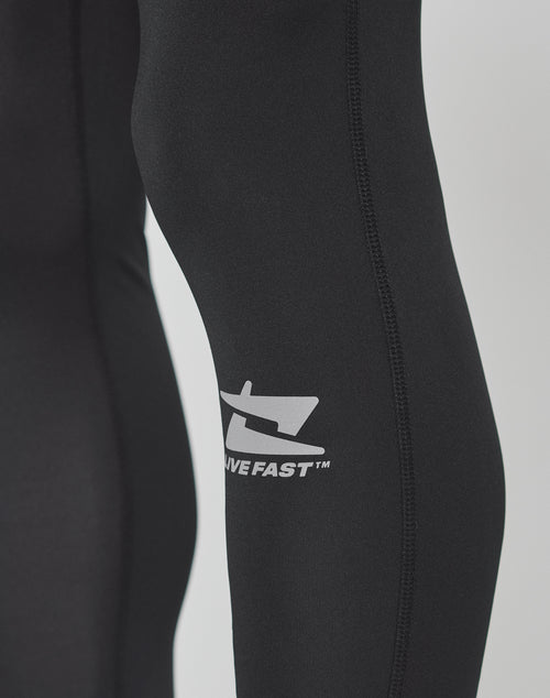 Close-up of a person wearing LIVE FAST DIE YOUNG Live Fast Performance Tights in black, featuring a white logo, DIVE FAST™ printed on the side, and a comfortable Elastikbund for added support.