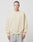 A person with short hair wears the LIVE FAST DIE YOUNG Basic Blank Sweater in light beige with a loose, oversize fit and soft Baumwolle, paired with light gray pants and standing against a plain white background.