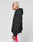 A person with short blond hair wears an oversize fit LIVE FAST DIE YOUNG Basic 360 Hooded black hoodie and white shorts with red stripes, standing in profile against a plain white background. Subtle topstitching adds detail.
