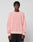 A person with short, textured hair wears the LIVE FAST DIE YOUNG LFDY Knit Sweater in light pink with dropped shoulders and black pants, standing against a plain light gray background.