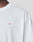 A close-up of a person wearing the LIVE FAST DIE YOUNG Live Fast Vegas Tee, a plain white T-shirt featuring small red LFDY™ text on the left chest. The Oversize Fit highlights the upper torso and part of the neck.
