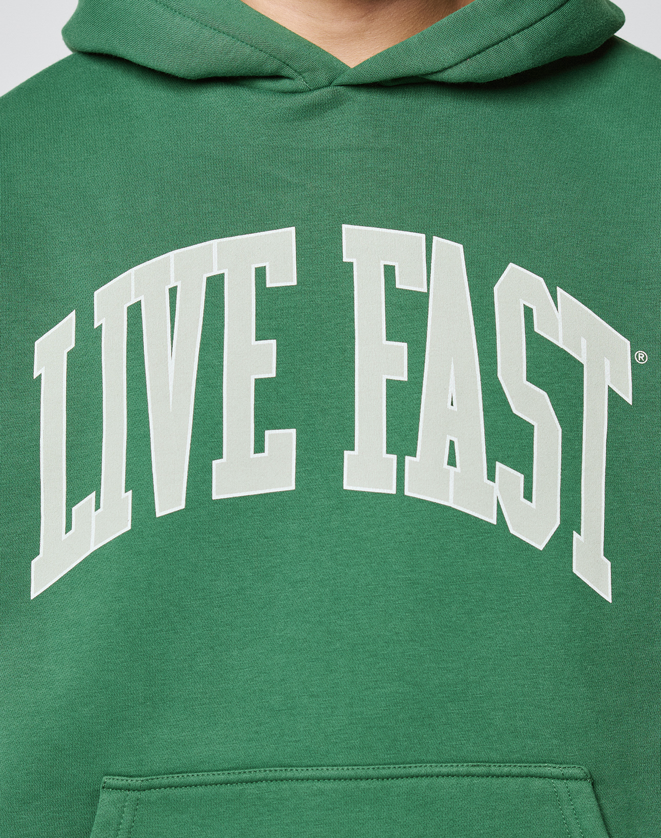 The Live Fast College Hooded by LIVE FAST DIE YOUNG is a green oversized hoodie with a bold "LIVE FAST" white front print, made from a soft cotton-polyester blend for comfort and style.