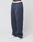 A person wears loose-fitting, dark blue LFDY Heavyweight Loungepants by LIVE FAST DIE YOUNG—650gsm 100% Baumwolle, side pockets, signature waistband. Image features only the lower body against a plain background.