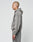 A person with a shaved head stands in profile, wearing a loose gray LIVE FAST DIE YOUNG Basic Hooded Zip in a Leicht Cropped Fit with matching sweatpants and subtle logo print, set against a plain light background.