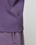 Close-up of a person wearing the Basic OS Livefast Tee and matching purple pants in an oversized fit by LIVE FAST DIE YOUNG. The image highlights the side seam and pocket area. Made from 100% cotton.