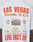 The Live Fast Vegas Tee by LIVE FAST DIE YOUNG is a white 100% Baumwolle shirt with bold red and gold LAS VEGAS, Nevada, U.S.A. text, event details, a desert road image, and LIVE FAST, DIE YOUNG at the bottom in an oversized fit.