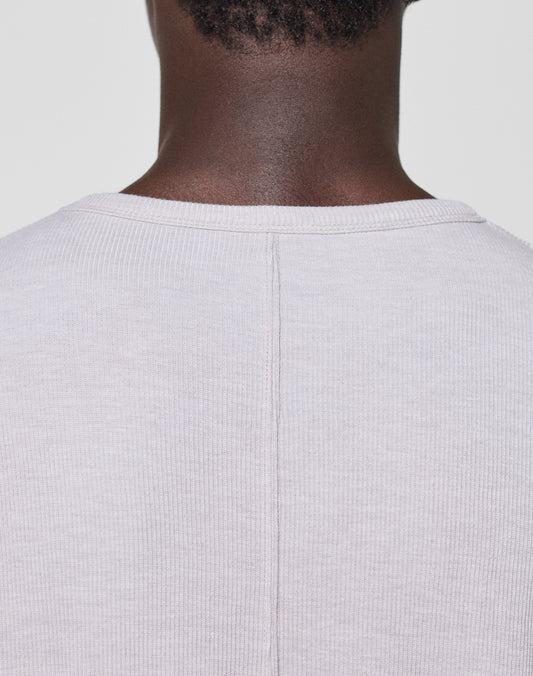 Close-up of the back neck and shoulders wearing the LFDY Rib Longsleeve by LIVE FAST DIE YOUNG—a light beige ribbed shirt featuring a central seam and subtle topstitching, set against a plain light background.