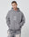 A man wears the LFDY Stitched Hooded by LIVE FAST DIE YOUNG, an oversized gray cotton-polyester hoodie with Live Fast Die Young text, paired with matching light gray pants featuring artistic designs.
