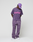 A person wears an oversize fit purple Basic OS Livefast Tee by LIVE FAST DIE YOUNG (100% Baumwolle) with a pink front print, purple cap, and matching sweatpants, standing on a plain white background with hands behind their back.
