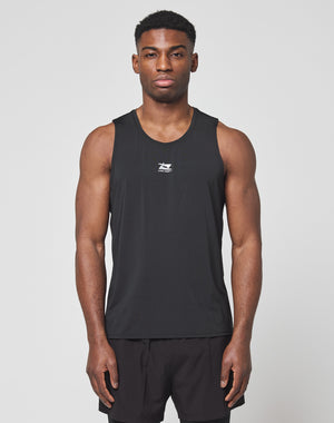 A man faces forward against a plain light background wearing the LIVE FAST DIE YOUNG Live Fast Performance Tank in slim fit black nylon spandex, paired with matching black shorts.