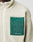 A close-up of the Basic Teddy Jacket by LIVE FAST DIE YOUNG in cream fleece with a standing collar and green zippered chest pocket. LiveFastDieYoung is printed in white near the bottom. Features a white zipper and comfortable regular fit.