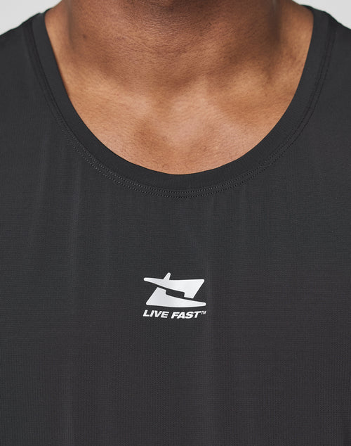 Close-up of a person wearing the black Live Fast Performance Tank by LIVE FAST DIE YOUNG, featuring a white logo and LIVE FAST in reflective print. Image shows only the neck and upper chest.