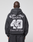 Someone wearing the LIVE FAST DIE YOUNG LFDY Run Club Hooded Zip, a black oversized hoodie featuring bold white graphics on the back: "Live Fast Run Club," "49," "Outrun The Dogs," and a snarling dog head. Made from cotton-polyester.