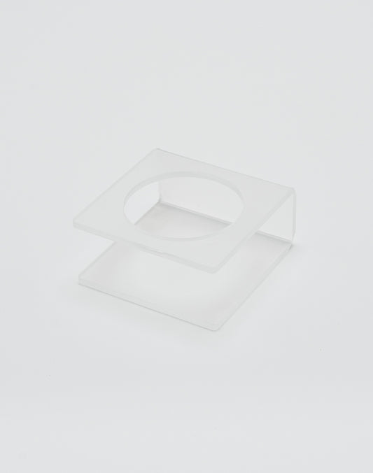 The LIVE FAST DIE YOUNG Live Fast Basketball is displayed on a clear, square acrylic stand with deep grooves and a circular cutout in the top panel, shown against a plain white background.