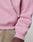 A close-up of a person wearing the LFDY Vandals Hooded Zip by LIVE FAST DIE YOUNG in light pink Oversize Fit, featuring ribbed cuffs and hem, paired with beige pants. The image highlights the sleeve and side seam details.