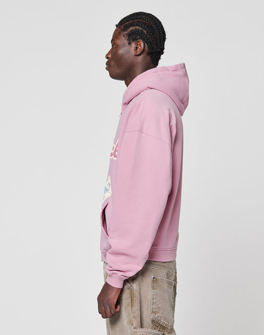 A person with braided hair stands in profile wearing the LIVE FAST DIE YOUNG LFDY Vandals Hooded Zip with individuelle Distressings and tan oversized cargo pants against a plain white background.