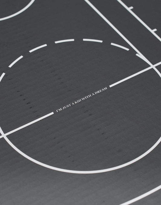A close-up of a black Live Fast Basketball with white lines, LIVE FAST DIE YOUNG branding, and deep grooves, featuring IM JUST A KID WITH A DREAM at the center.