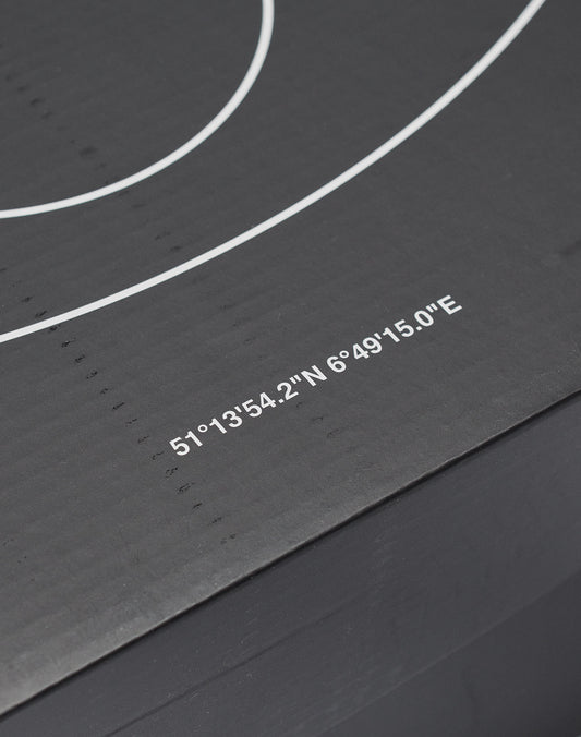 A close-up of the Live Fast Basketball by LIVE FAST DIE YOUNG shows its black surface with deep grooves, white concentric circles, printed coordinates—51°1354.2N 6°4915.0E—and subtle brand logo.