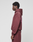 A person in an oversize fit maroon LIVE FAST DIE YOUNG Basic 360 Hooded sweatshirt and sweatpants stands in profile against a plain light gray background. The hoodie, made from weicher Baumwolle, features a hood up and subtle front and back prints.