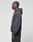 A person stands in profile against a plain background, wearing a dark gray LIVE FAST DIE YOUNG LFDY 40 Hoodie with the hood down, classic Kangaroo pocket, and matching sweatpants.