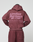 A person in a maroon Basic 360 Hooded and matching pants by LIVE FAST DIE YOUNG, seen from the back. The hoodie features large pink "LiveFast Bordeaux 18-1718" text and additional smaller print on the front and back.