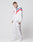 A man with short hair and visible neck and hand tattoos models LIVE FAST DIE YOUNG's LFDY x Trigema Trackpants—white trackpants with red and blue stripes, regular fit, paired with white sneakers, posed against a plain white background.