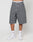 Someone stands against a plain light background wearing LFDY Jorts by LIVE FAST DIE YOUNG—long, baggy gray denim shorts with wide straight legs. Theyre styled with white socks, white sneakers, and underwear showing a visible LIVE FAST waistband.