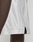Close-up of a person wearing LIVE FAST DIE YOUNG’s LFDY League Shorts, featuring brown and white panels with a bold "LFDY" logo print. The shiny fabric and visible stitching create a standout, sporty look.