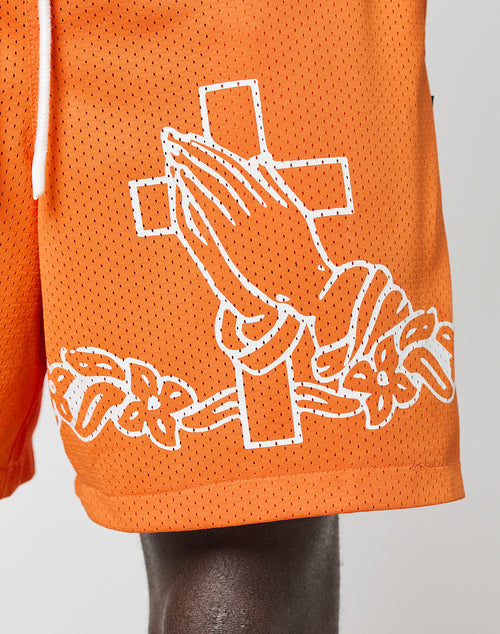 The LFDY Praying Mesh Shorts by LIVE FAST DIE YOUNG feature a white outline of praying hands and a cross with flowers on orange polyester, plus regular fit, Elastikbund, and a white drawstring for comfort.