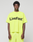 A person wears the LIVE FAST DIE YOUNG Basic OS Livefast Tee in neon yellow, featuring an oversize fit and bold "LiveFast™" black front print, paired with matching shorts against a plain background. Made from 100% Baumwolle.